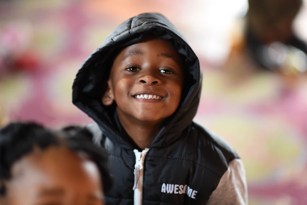 A happy young child in the Masibulele Educare Center.