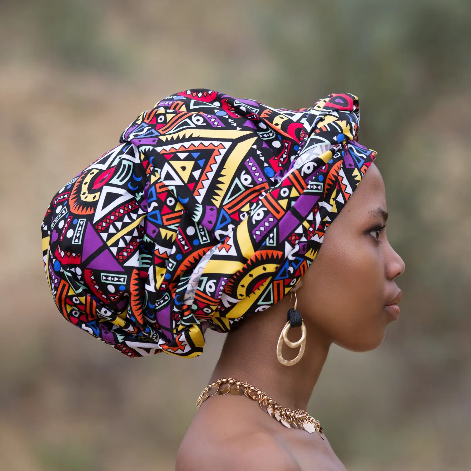 A lady wearing a traditional African headdress.