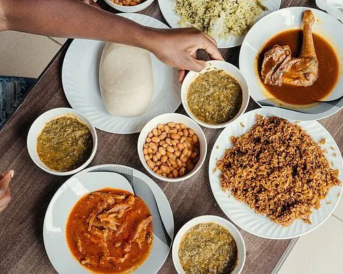 Various Rwandan cuisine being served in dishes on a table.