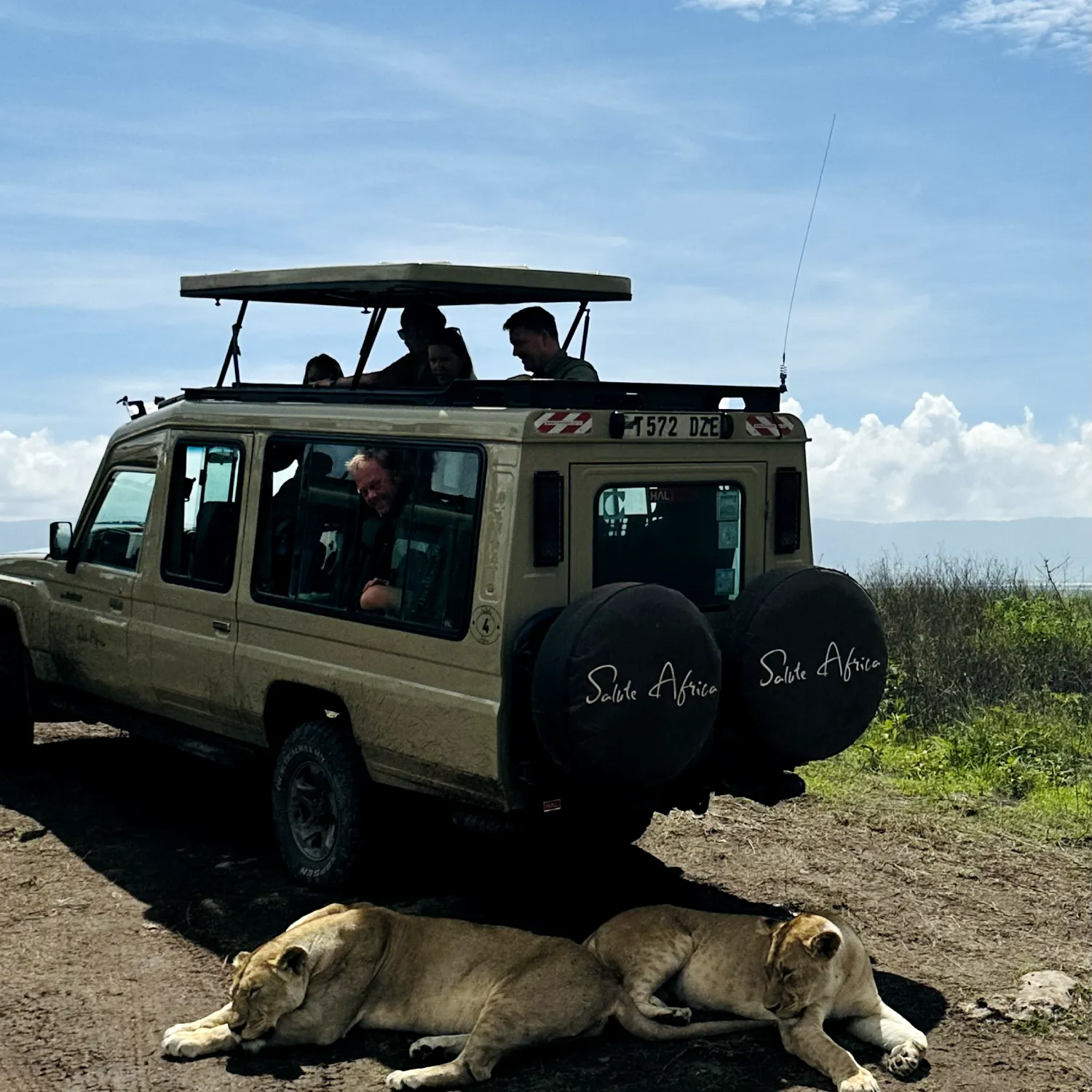 A Salute Africa branded, safari vehicle full of excited tourists