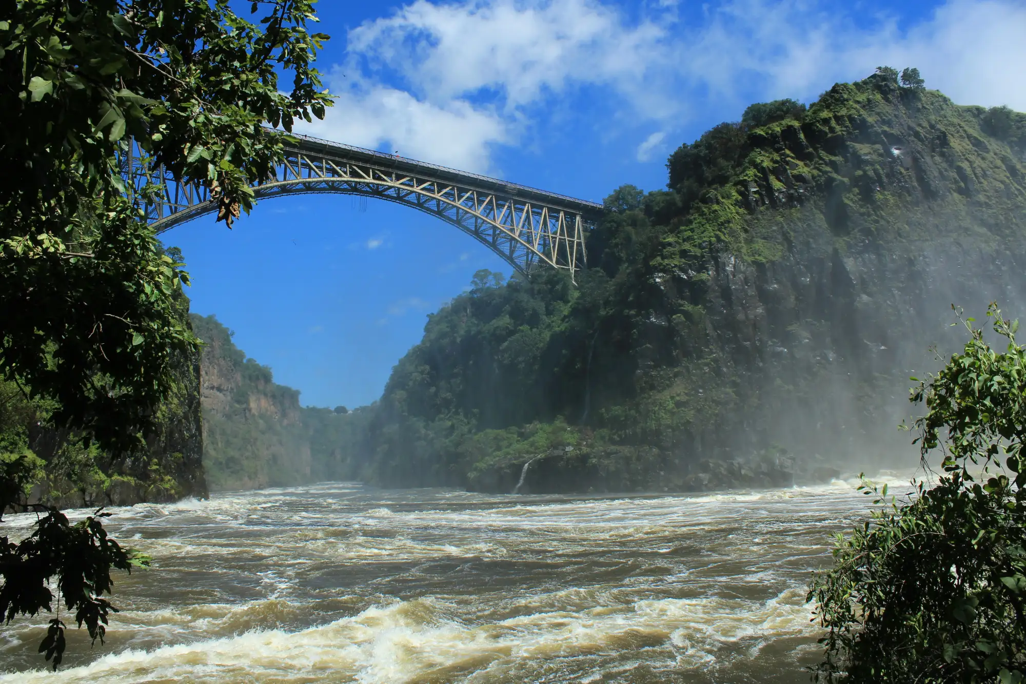 Victoria Falls viewed from the rocky waters below.